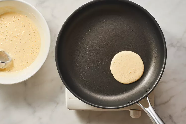 The pancake on the pan cooking